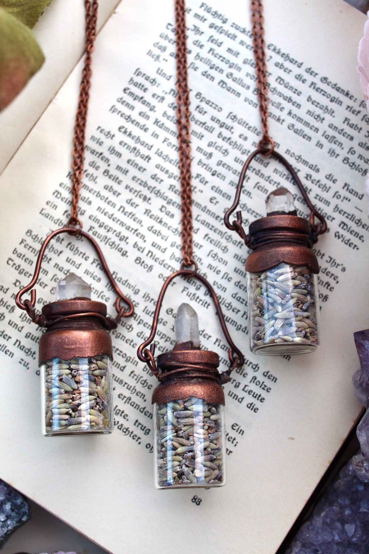 lavender necklace in a bottle with a clear quartz point