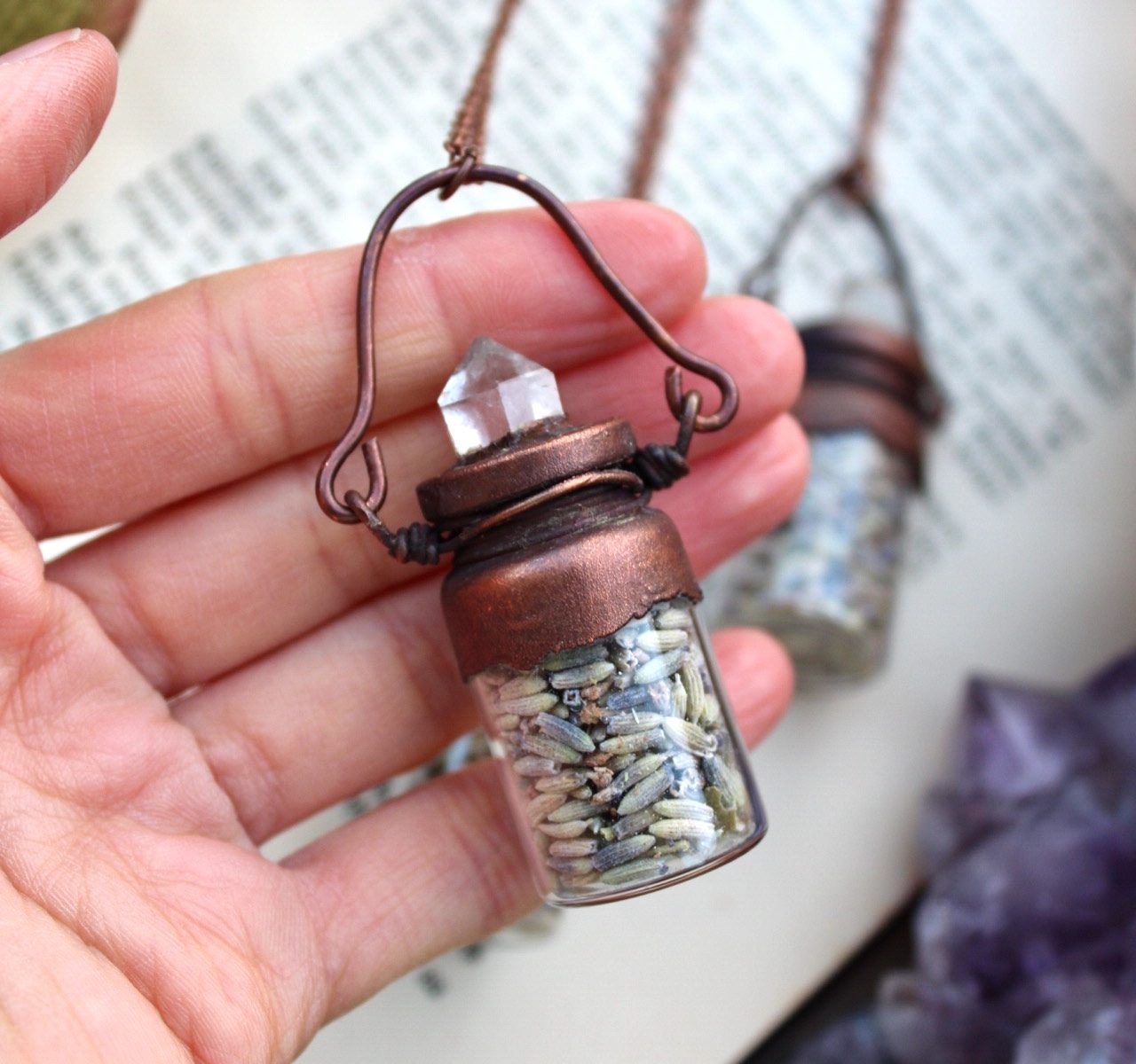 lavender necklace in a bottle with a clear quartz point